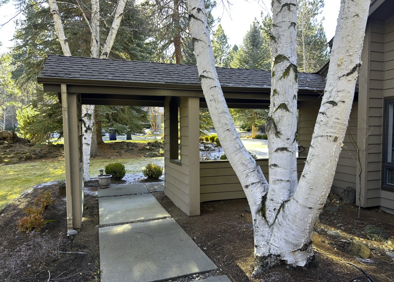 Mountain High entry before — original covered entry with old posts, winter