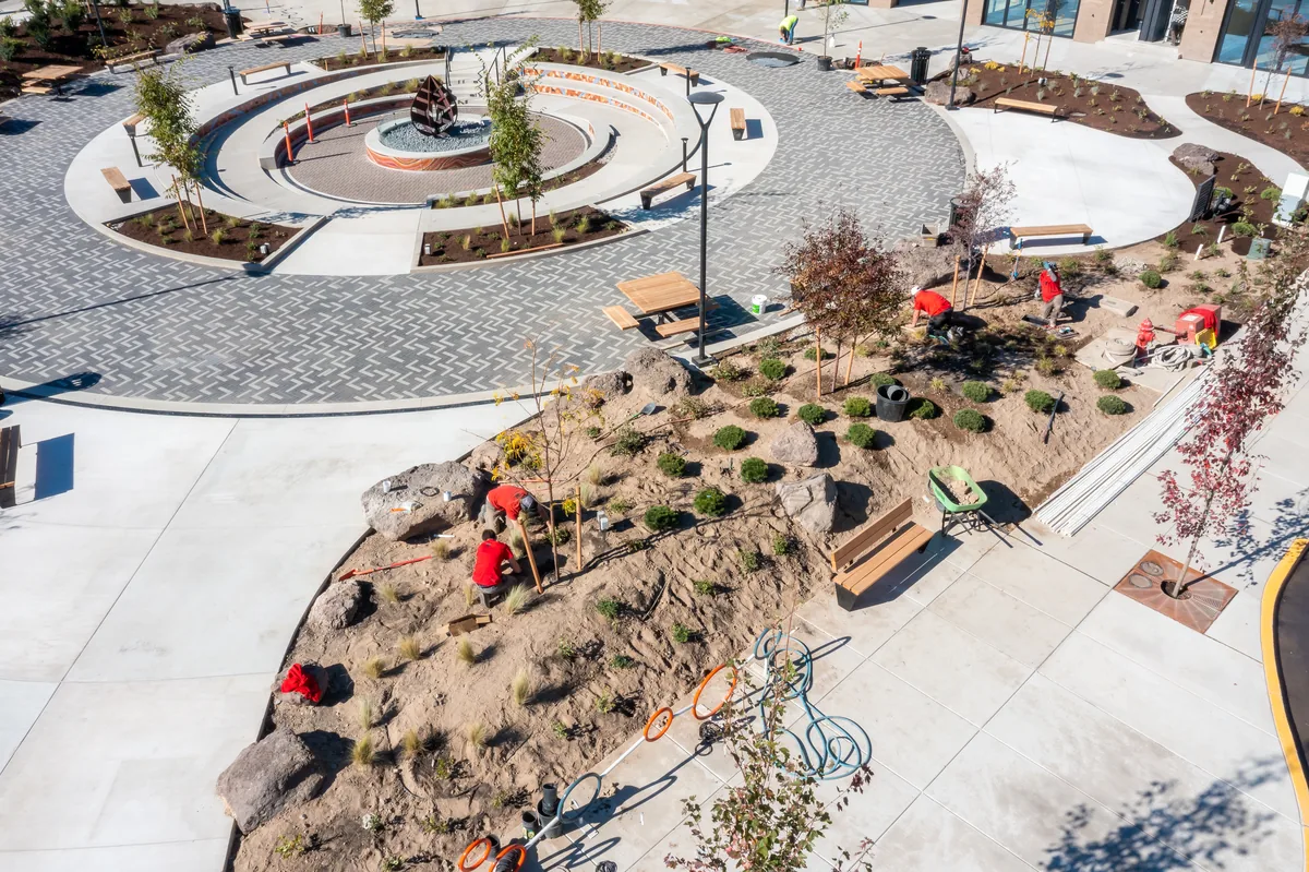 Discovery West Plaza — angled aerial with crew working