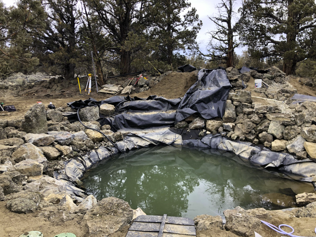 East Bend — construction: pond liner being unfolded by crew