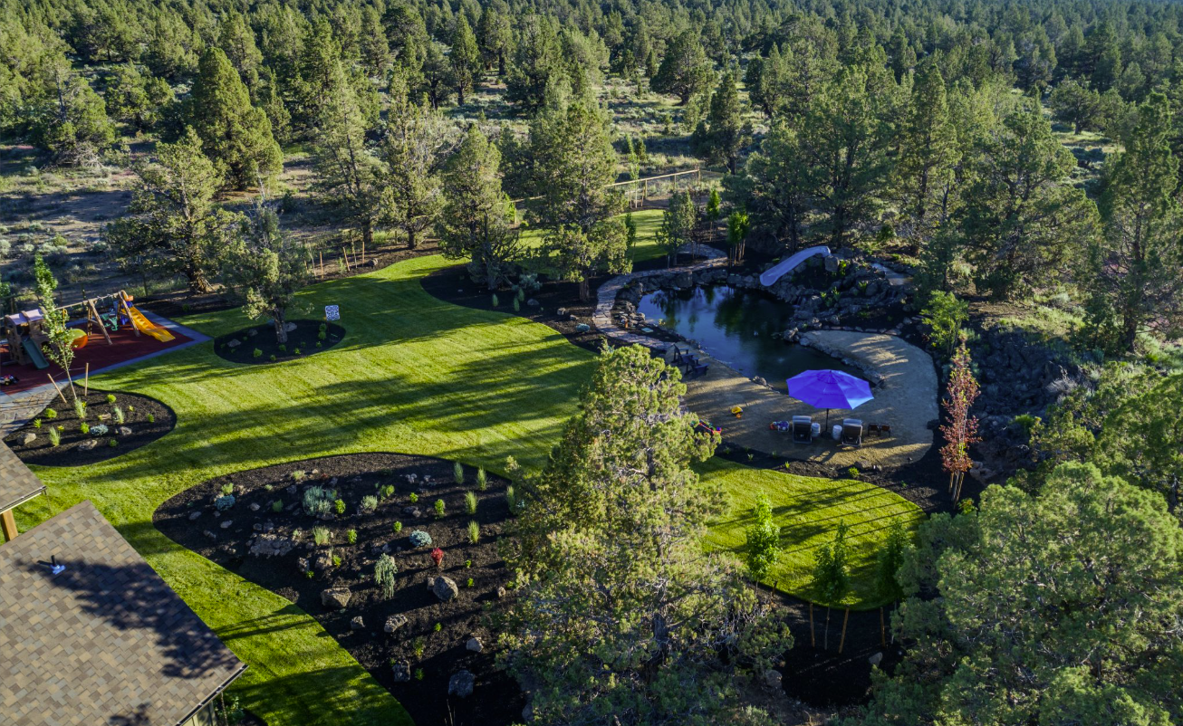 East Bend — aerial drone view of full property with pond, playground, and lawn
