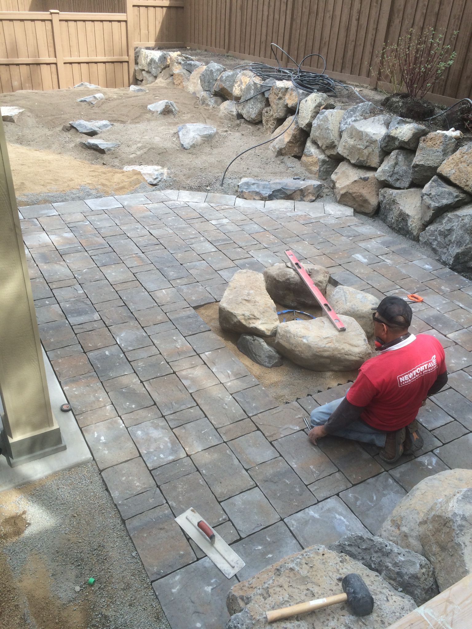 Newport Avenue crew leveling boulders for fire pit