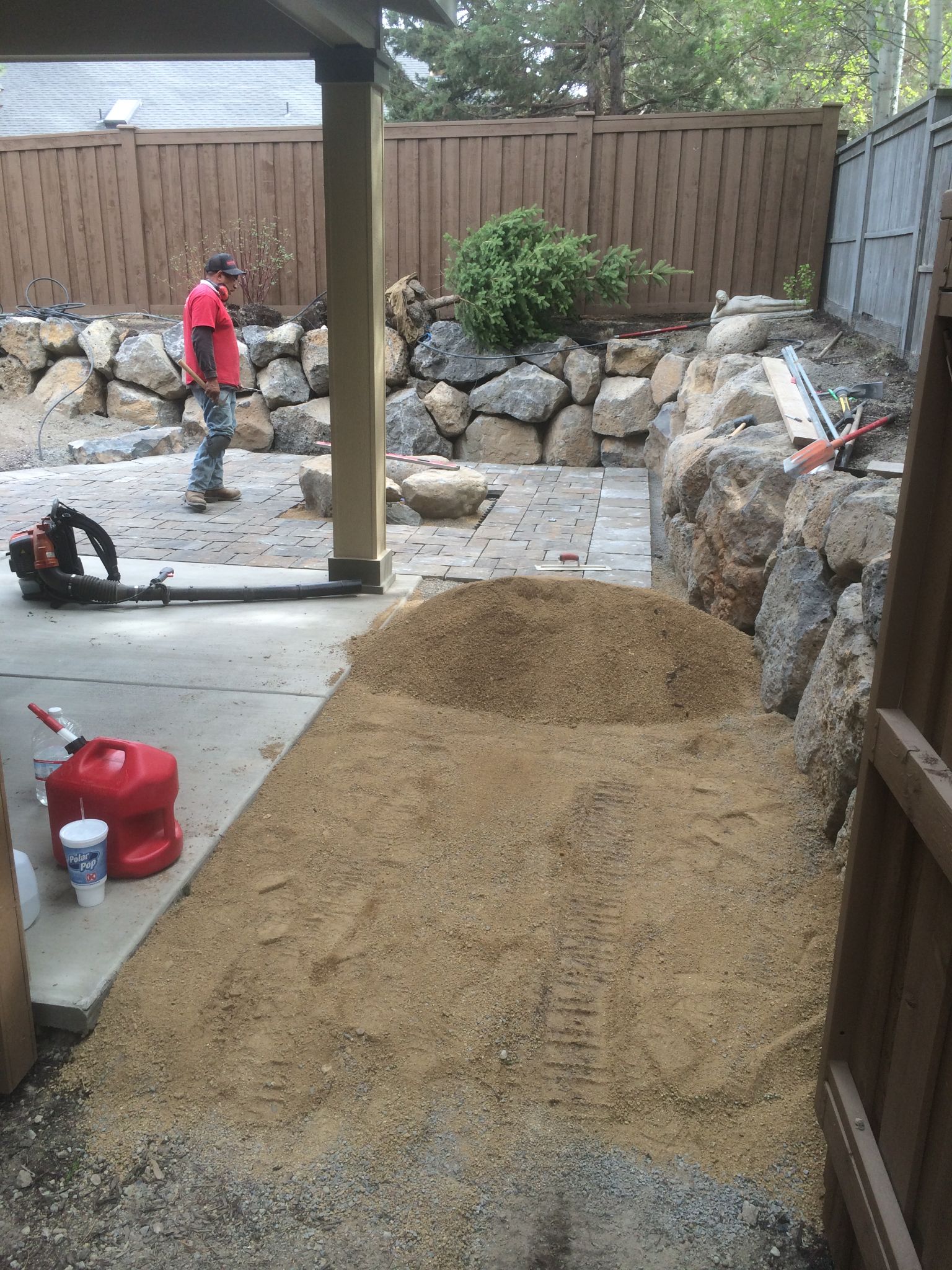Construction progress — paver patio and boulder wall taking shape