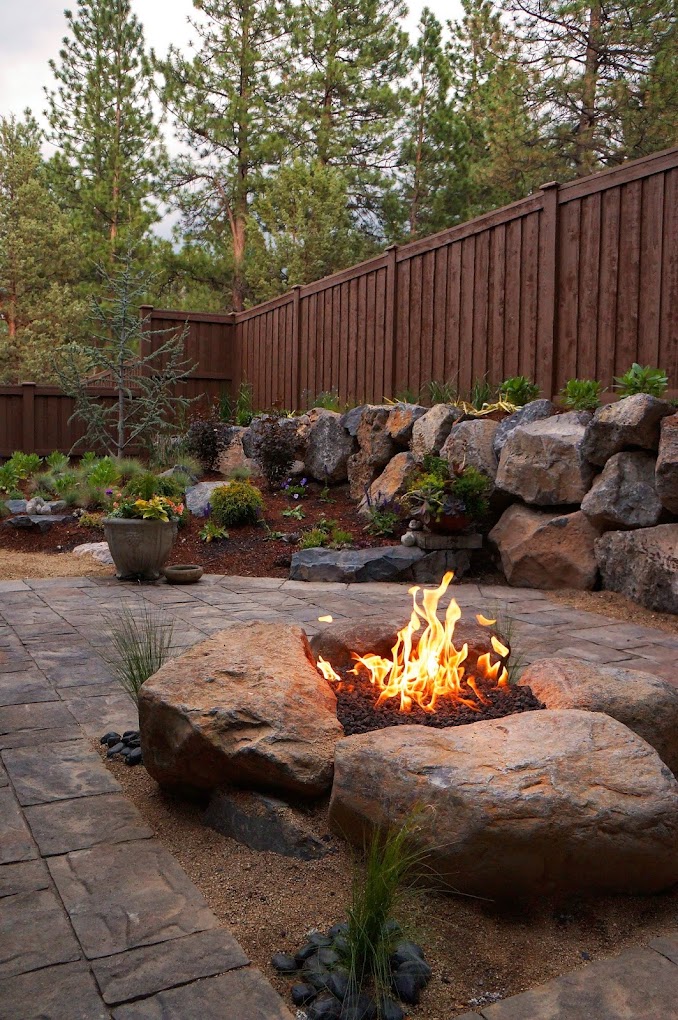 Finished boulder gas fire pit with Belgard paver patio — Bend, Oregon